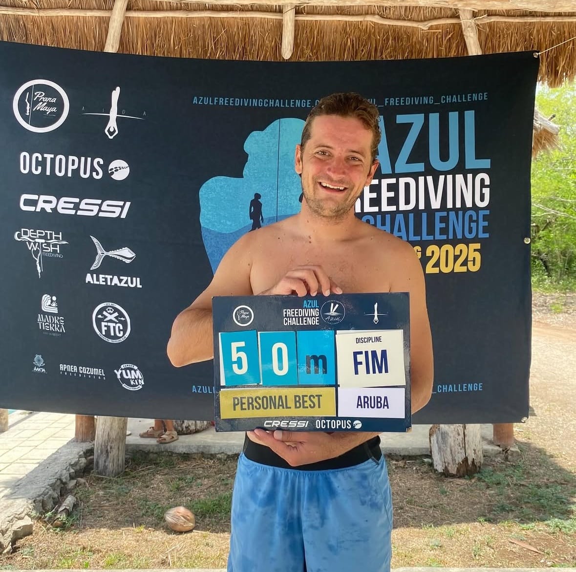 Tommy holding the 50-metre personal-best board at the 2025 Azul Freediving Challenge